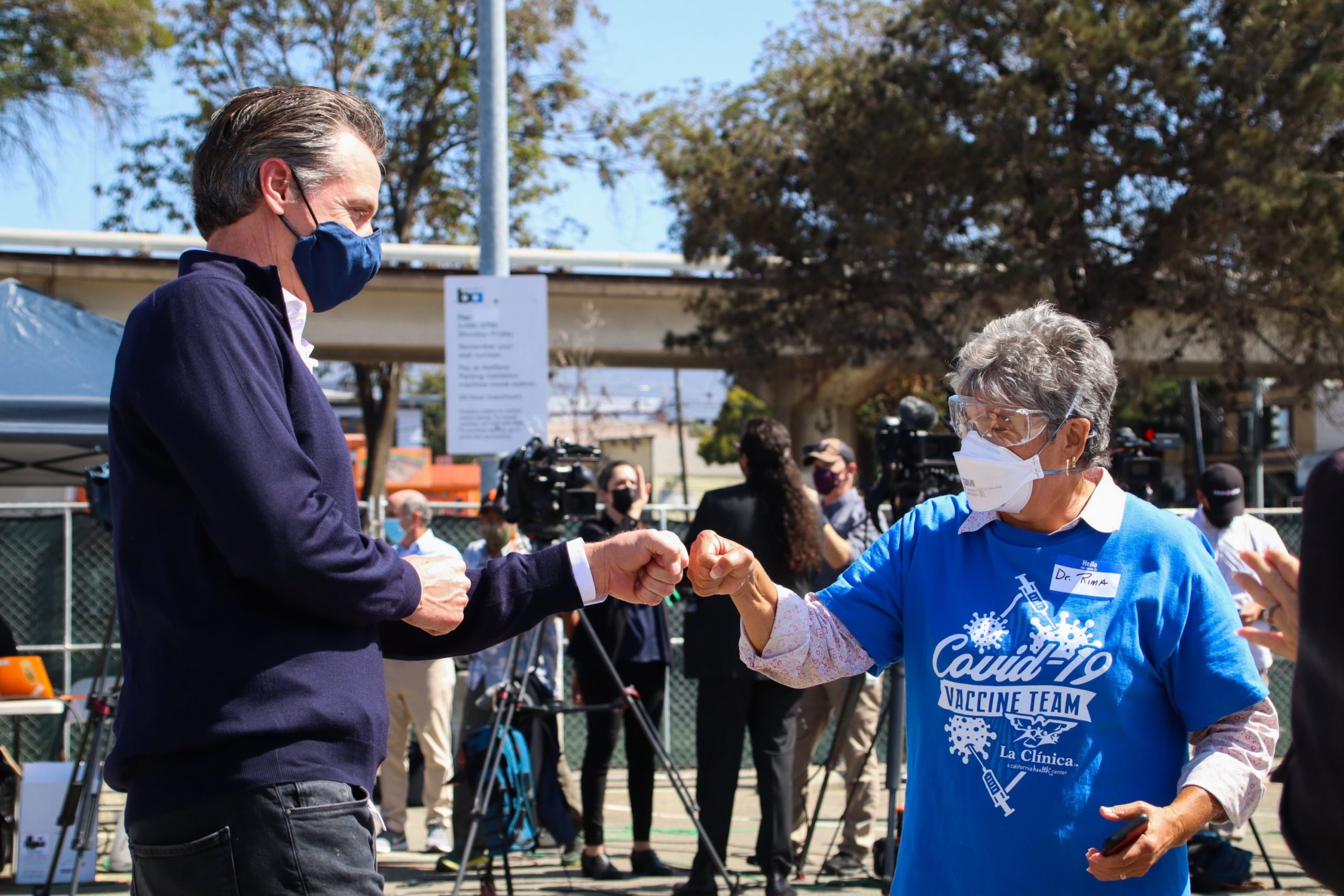 Governor Newsom fist bumps vaccination worker