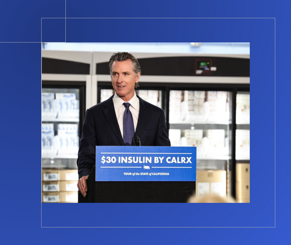 Governor Newsom stands behind a podium and in front of refrigerators with boxes of medication as he discusses insulin prices. A sign on the podium states, “ insulin by calrx. Tour of the state of California.”