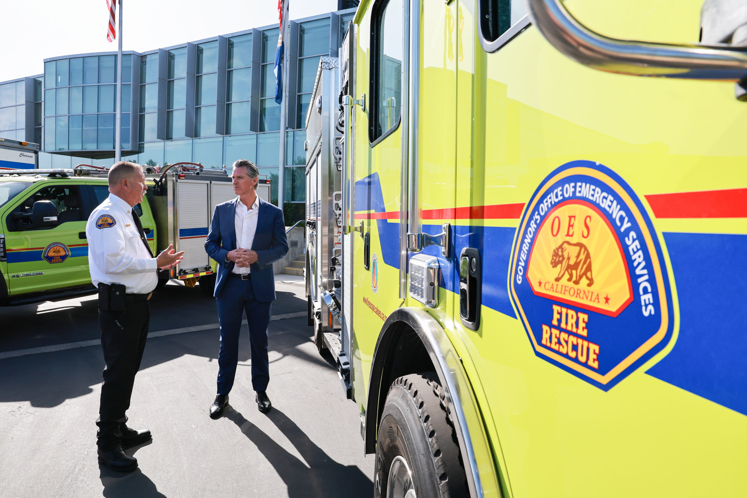 A photo of Governor Newsom and Cal OES Chief Marshall in front of a fire engine.