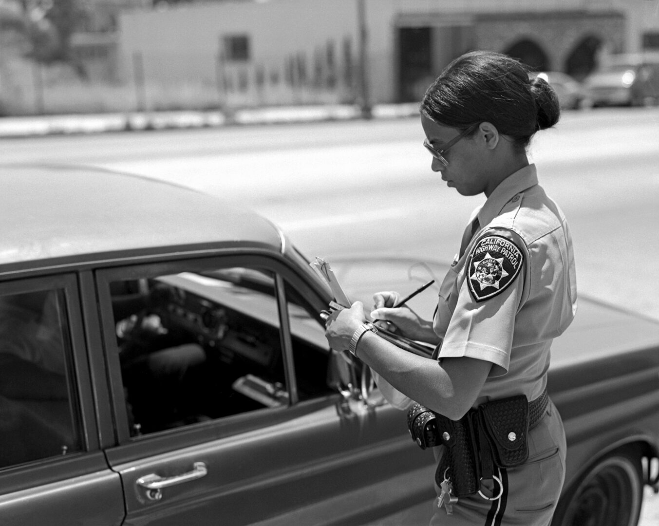 CHP officer writing a citation.