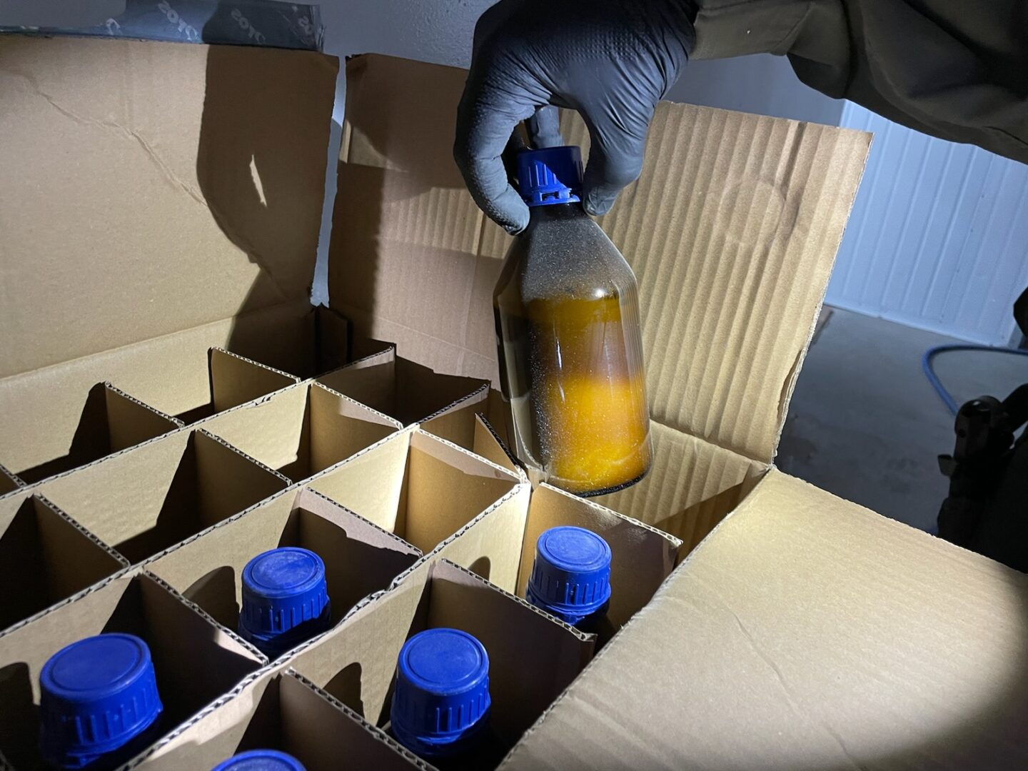 Box with bottles filled with chemicals