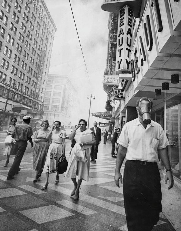 A man wearing a gas mask in Los Angeles in the mid-century.