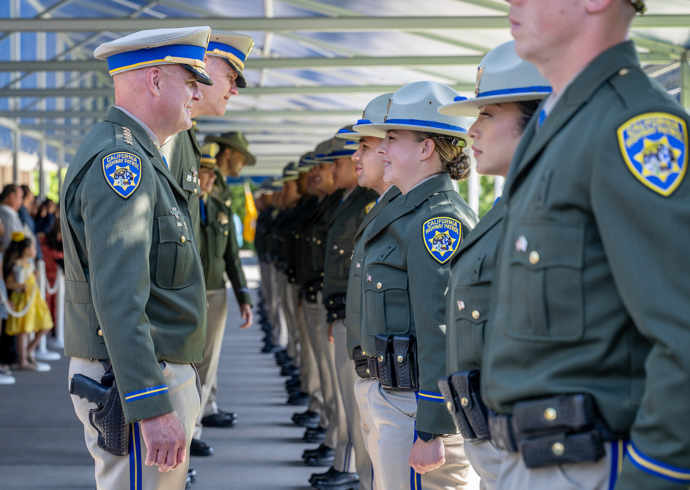 A photo with the CHP Commissioner recognizing the graduating class of CHP cadets.