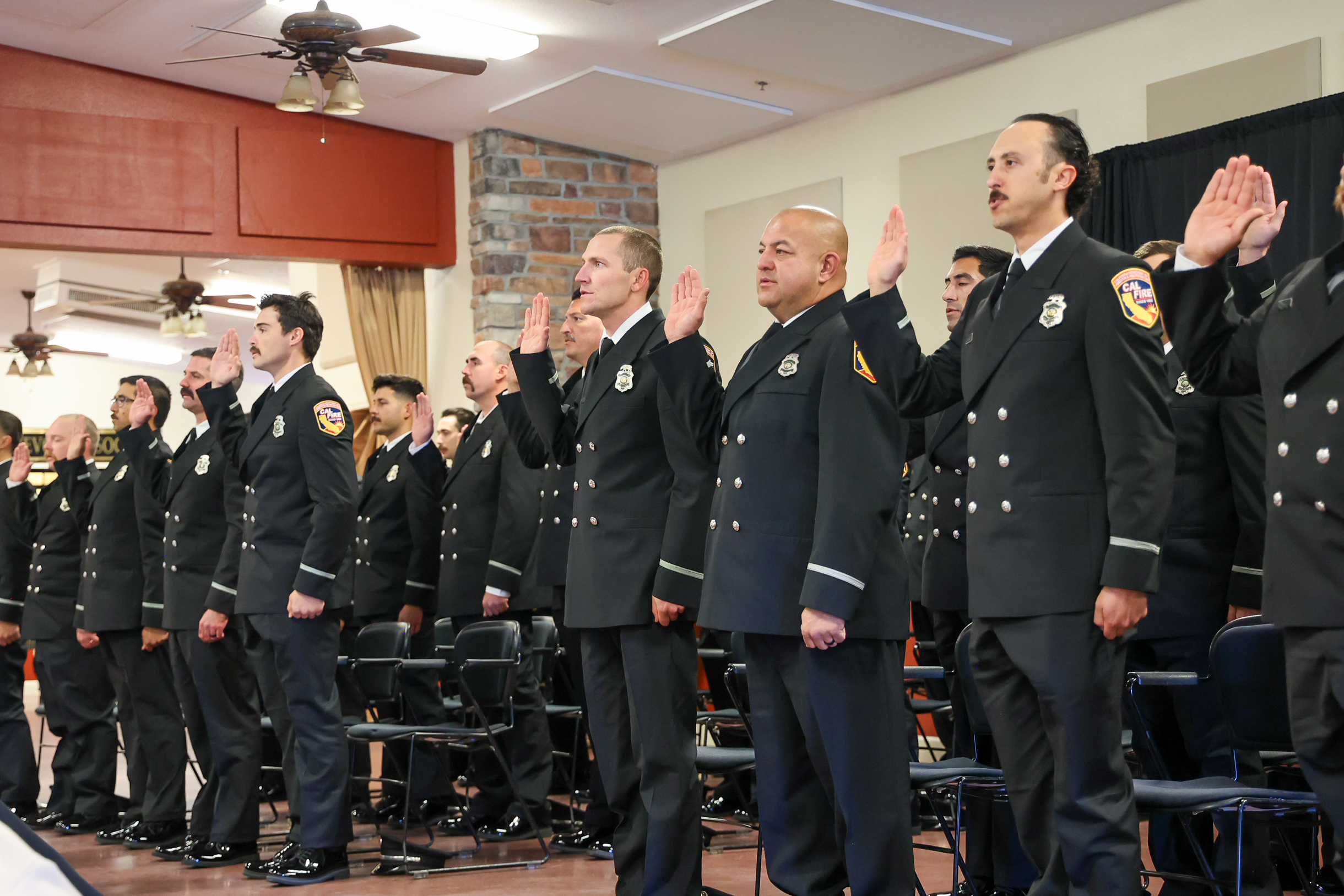 CAL FIRE graduates raise their right hands to take the oath.