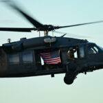 A photo of a CalGuard helicopter with an American flag.