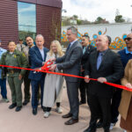 A photo of Governor Newsom and others cutting a ribbon at the San Quentin Learning Cent</div></div></div>
<div class=