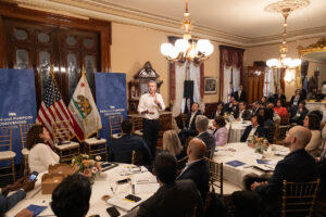 A photo of Governor Gavin Newsom speaking to a group of people