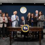 Governor Newsom alongside state legislators as he signing SB 417