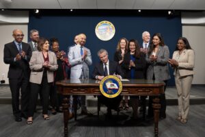 Governor Newsom alongside state legislators as he signing SB 417