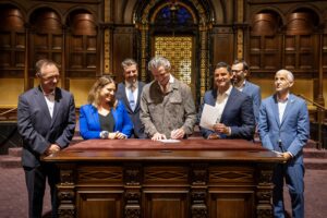 A photo of Governor Newsom at the Wilshire Temple signing two bills.